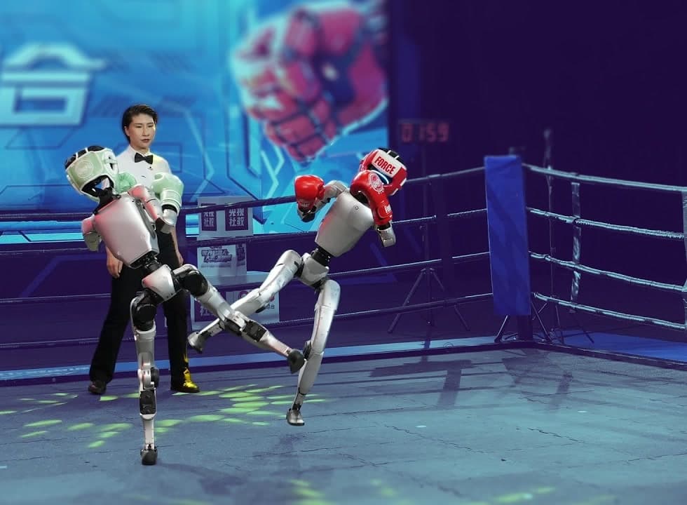 Two G1s exchanging kicks in the Iron Fist King ring with a referee behind them