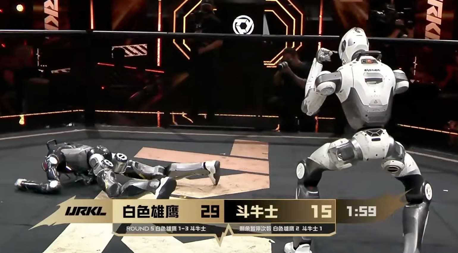 White Eagle seen from behind, standing over a downed Matador in round five of the URKL opening bout